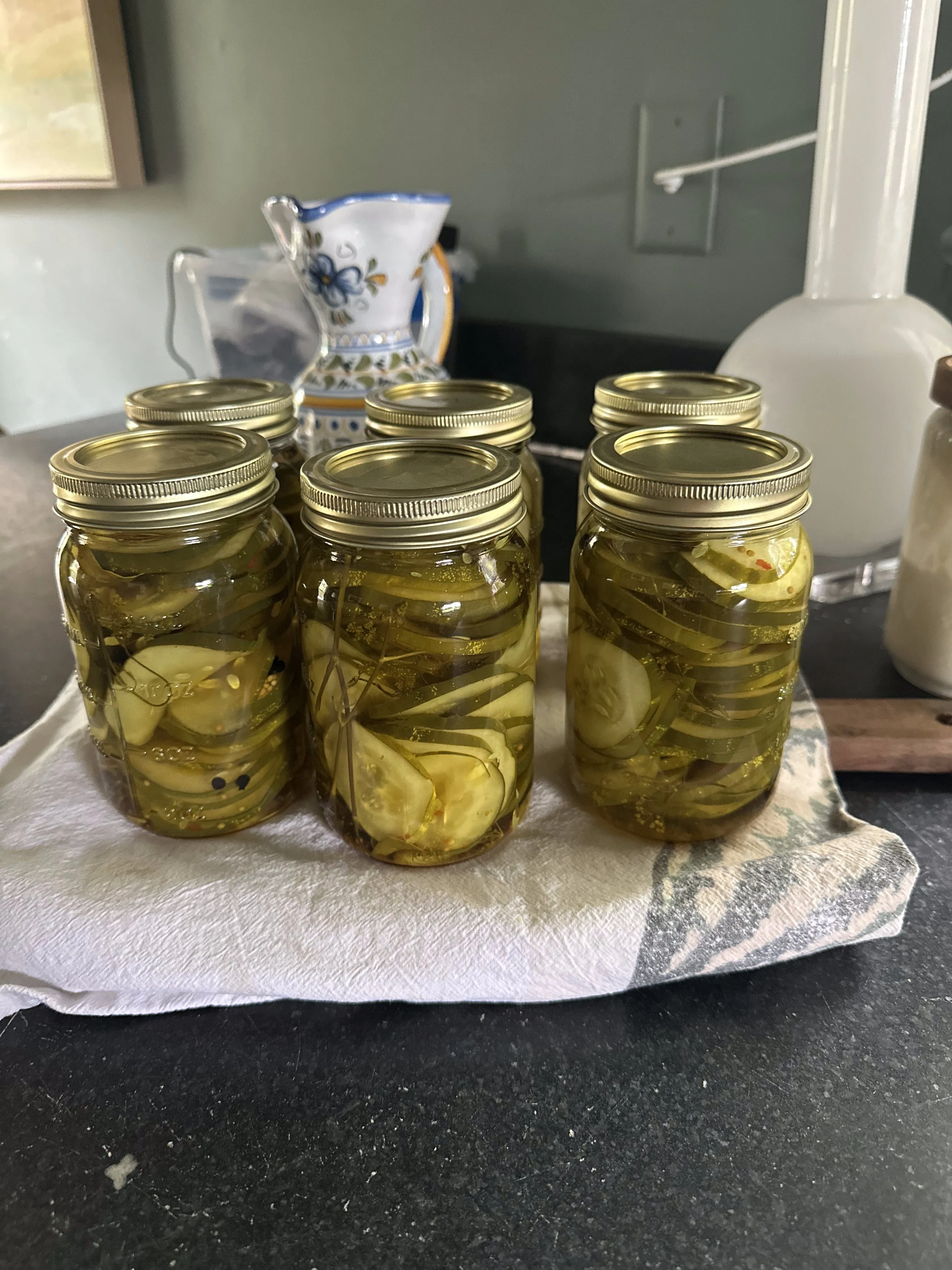 Canning jars filled with preserved garden pickles