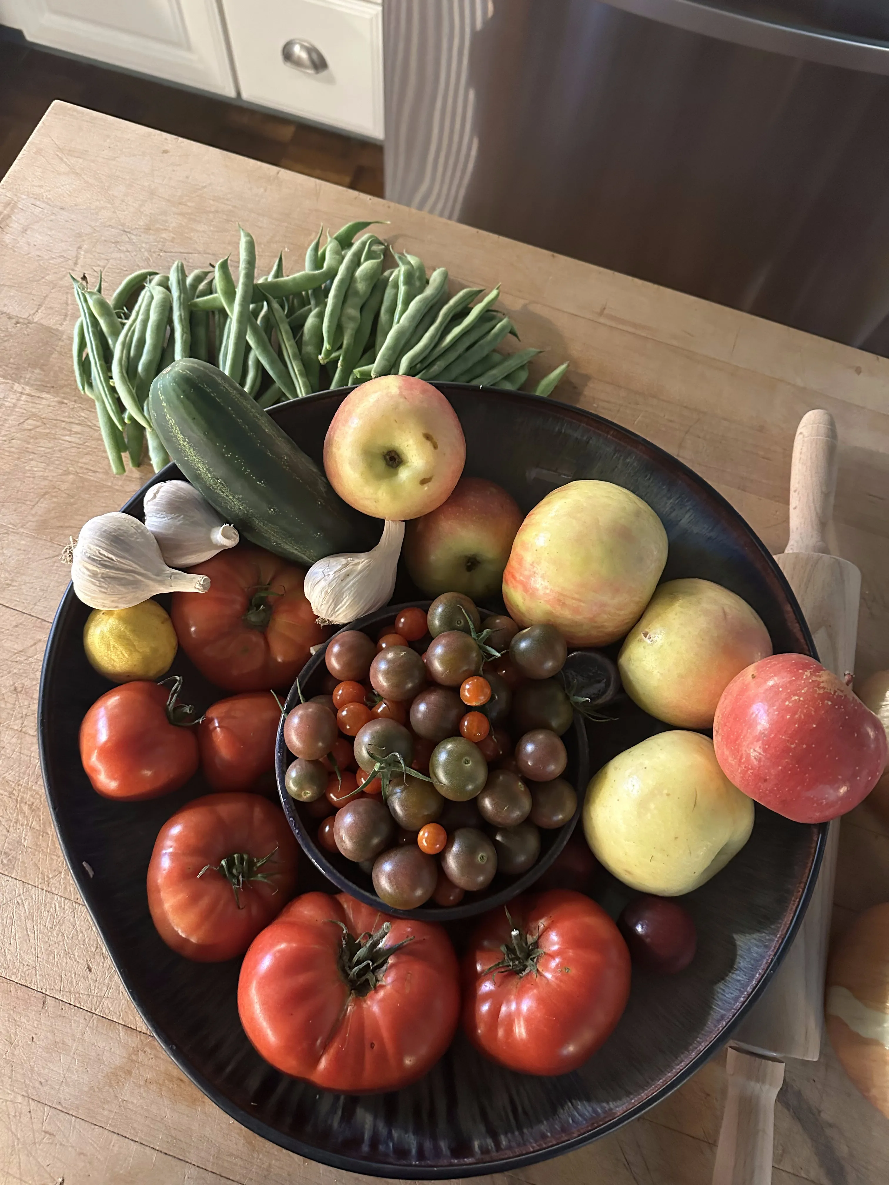 Platter of mixed garden produce including tomatoes and apples