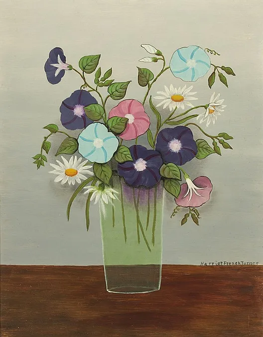 Morning glories and daisies growing along the garden fence