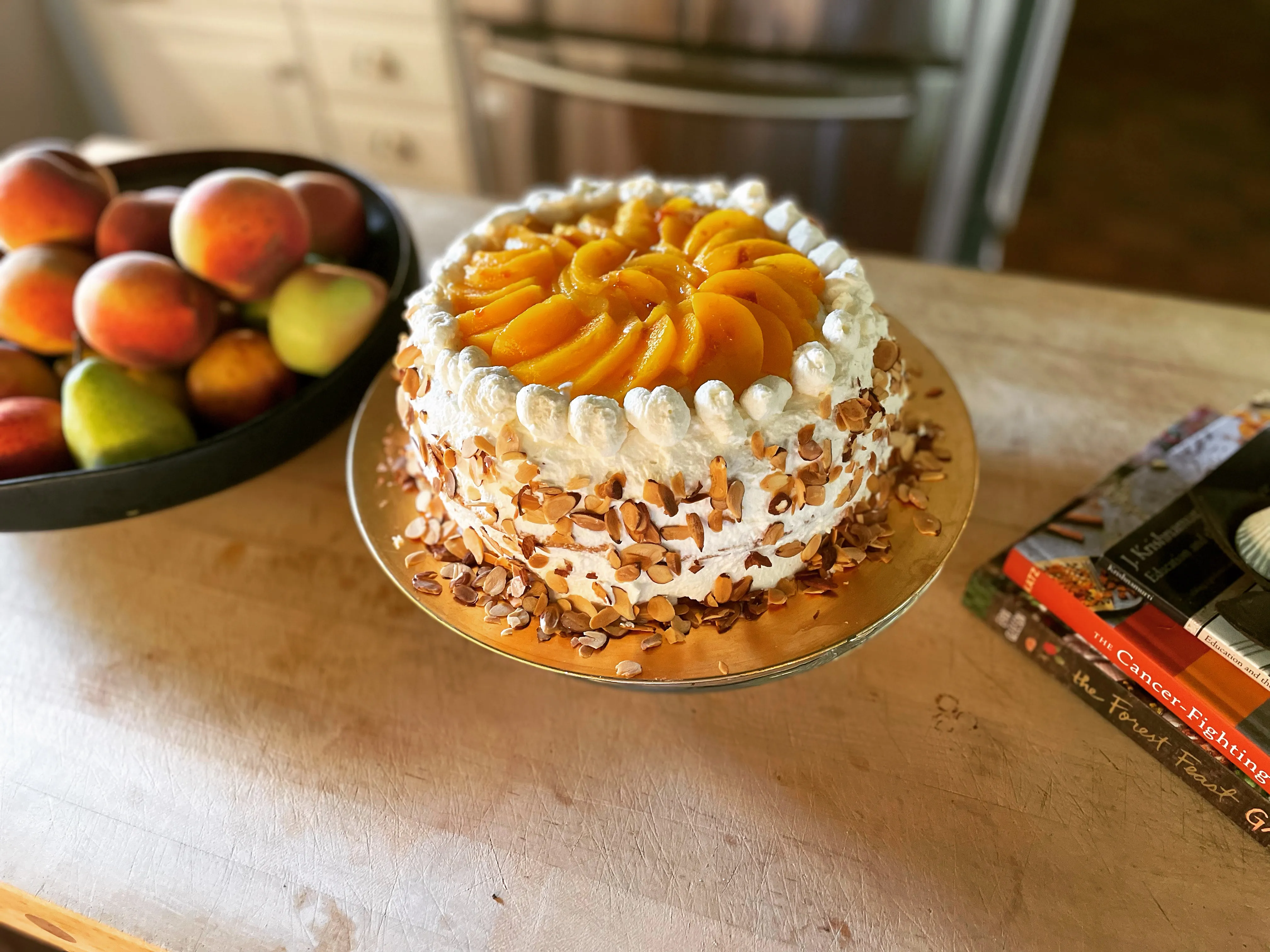 Peach chantilly cake with sliced peaches and toasted almonds